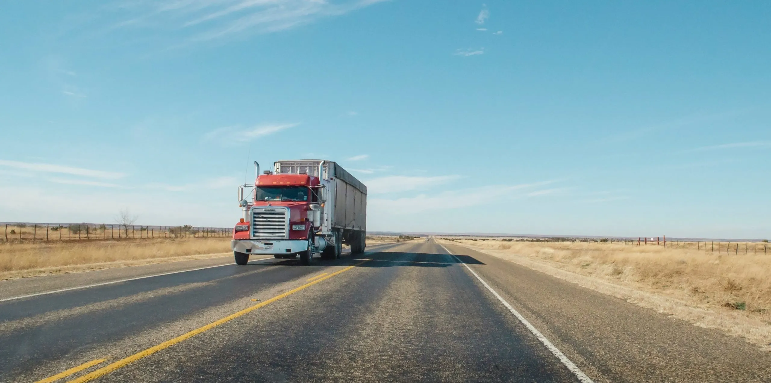 trailer truck passing on road during daytime