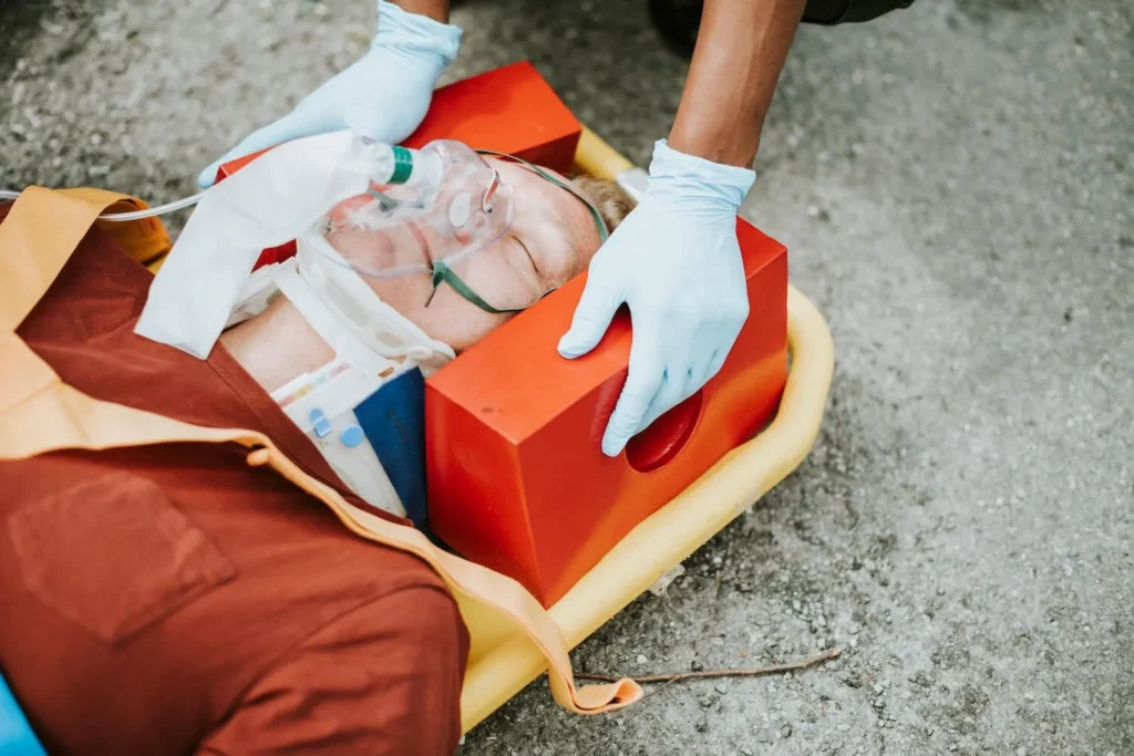 Paramedics securing a patient into a stretcher.
