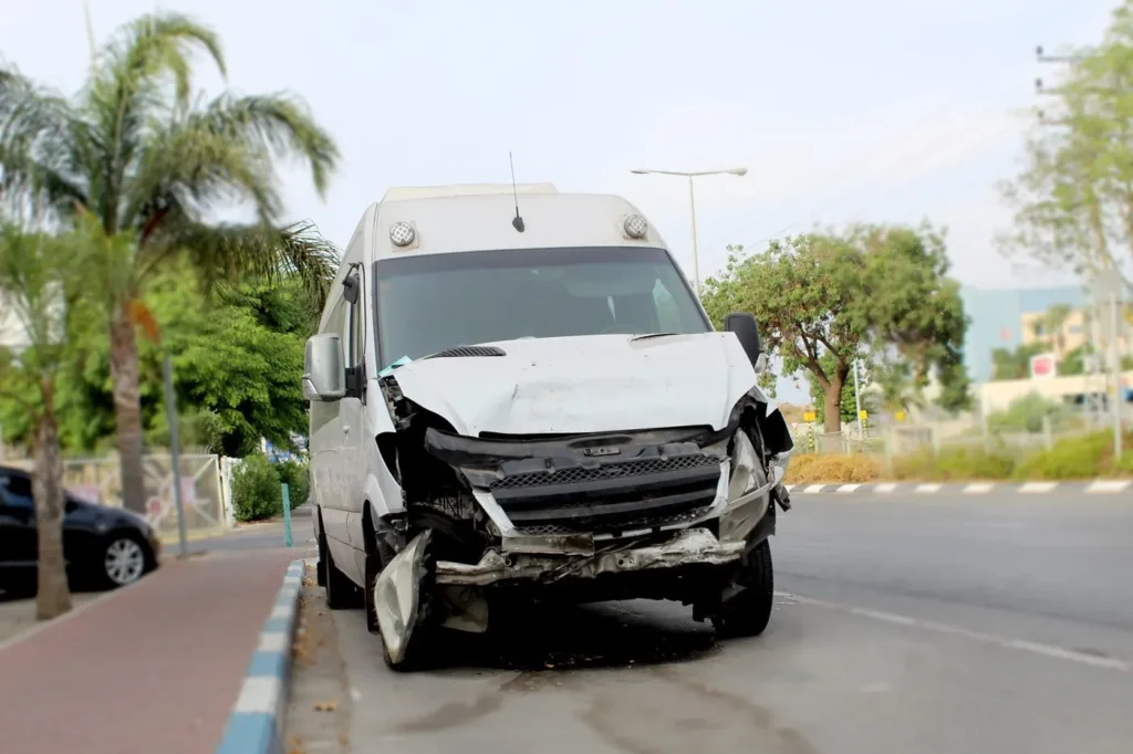 A commercial vehicle with severe front end damage.