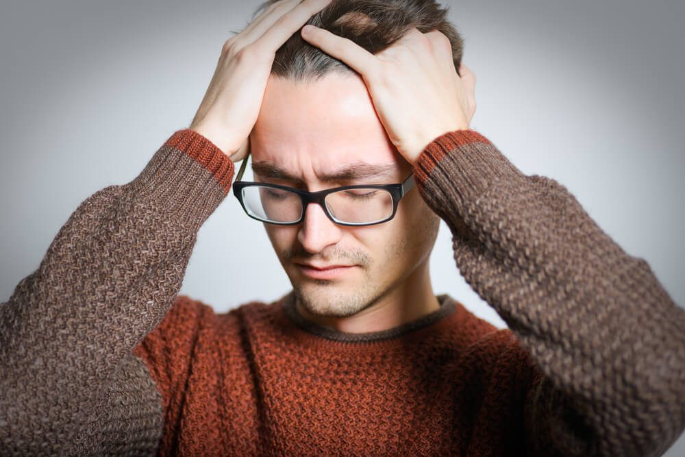 man has headache, injury, isolated on a gray background