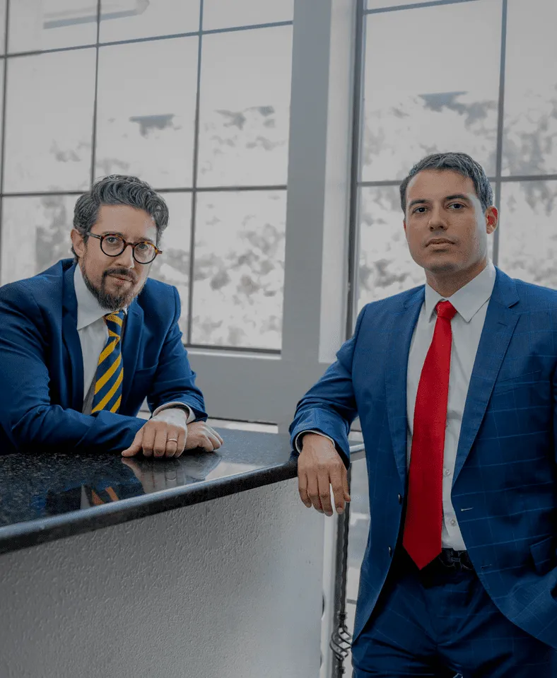 Legal team at Cesar Ornelas standing by a desk.