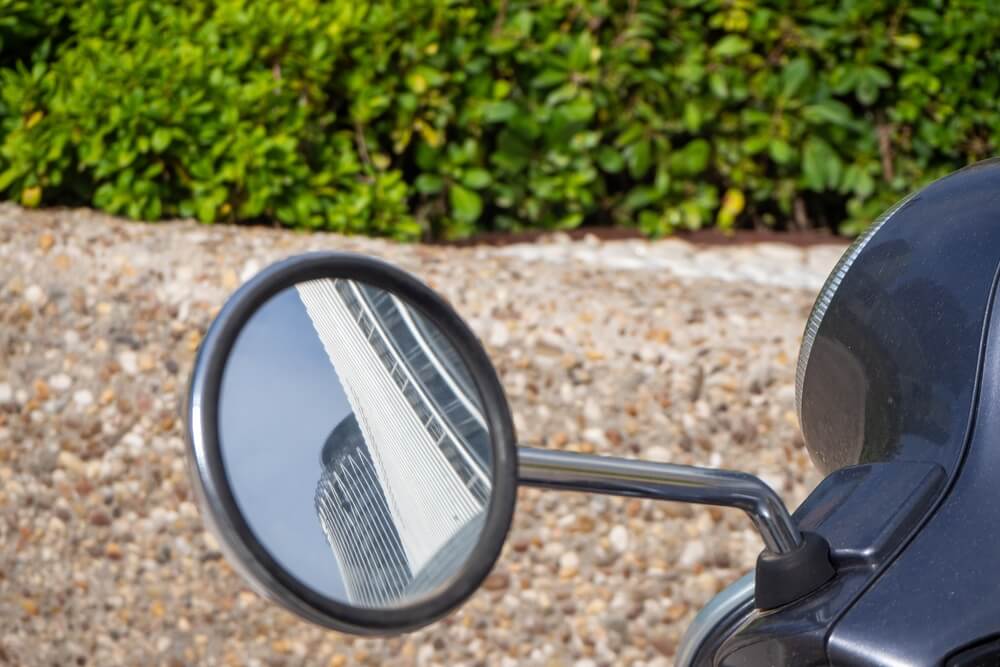 Two towers reflected on the motorbike mirrow