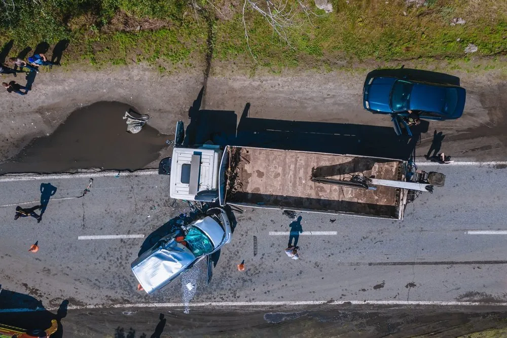 An aerial view of a several accident involving two cars and a commercial truck.