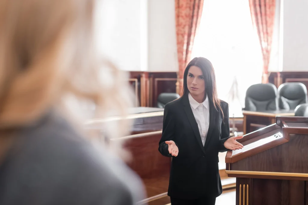 A lawyer questioning a witness in a court room.