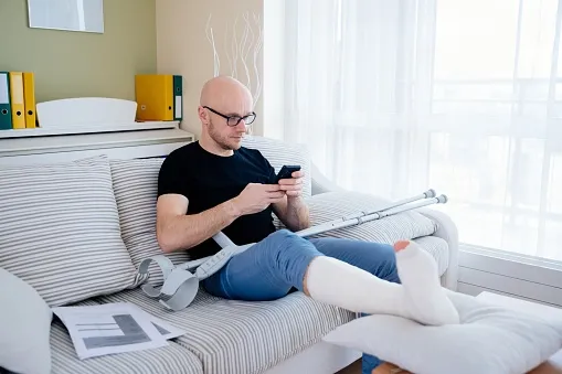 A person with an injured foot on the couch.